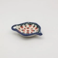 Ceramiczna podstawka z odłożoną torebką herbaty.